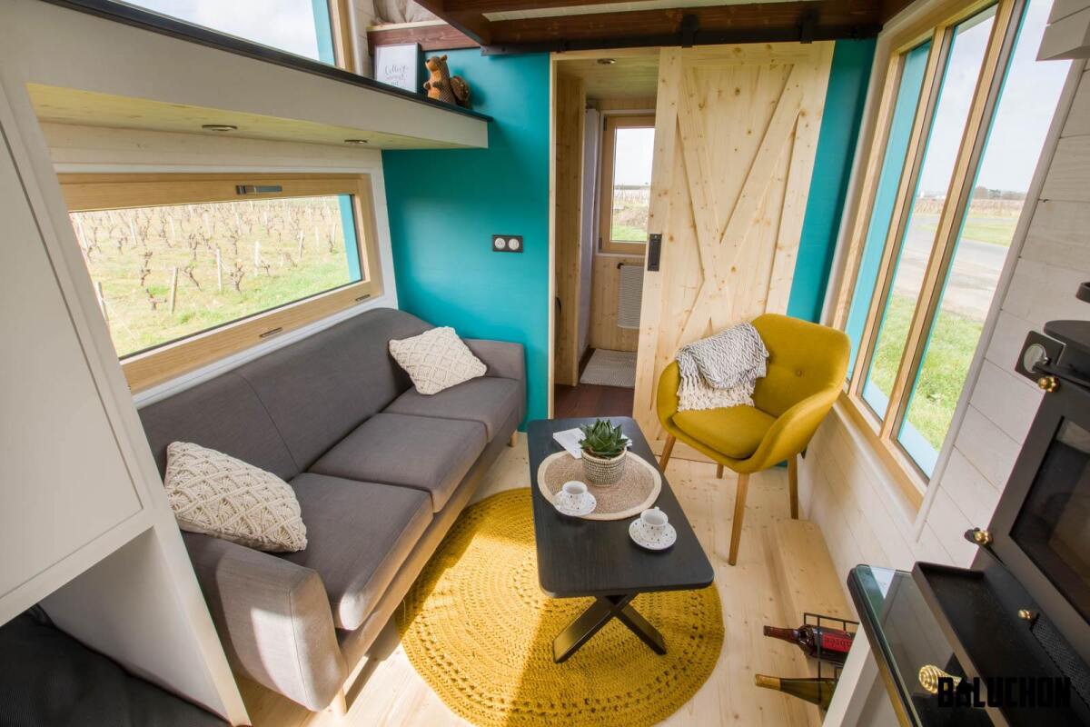 The Téméraire's living room includes a sofa, coffee table, and a chair